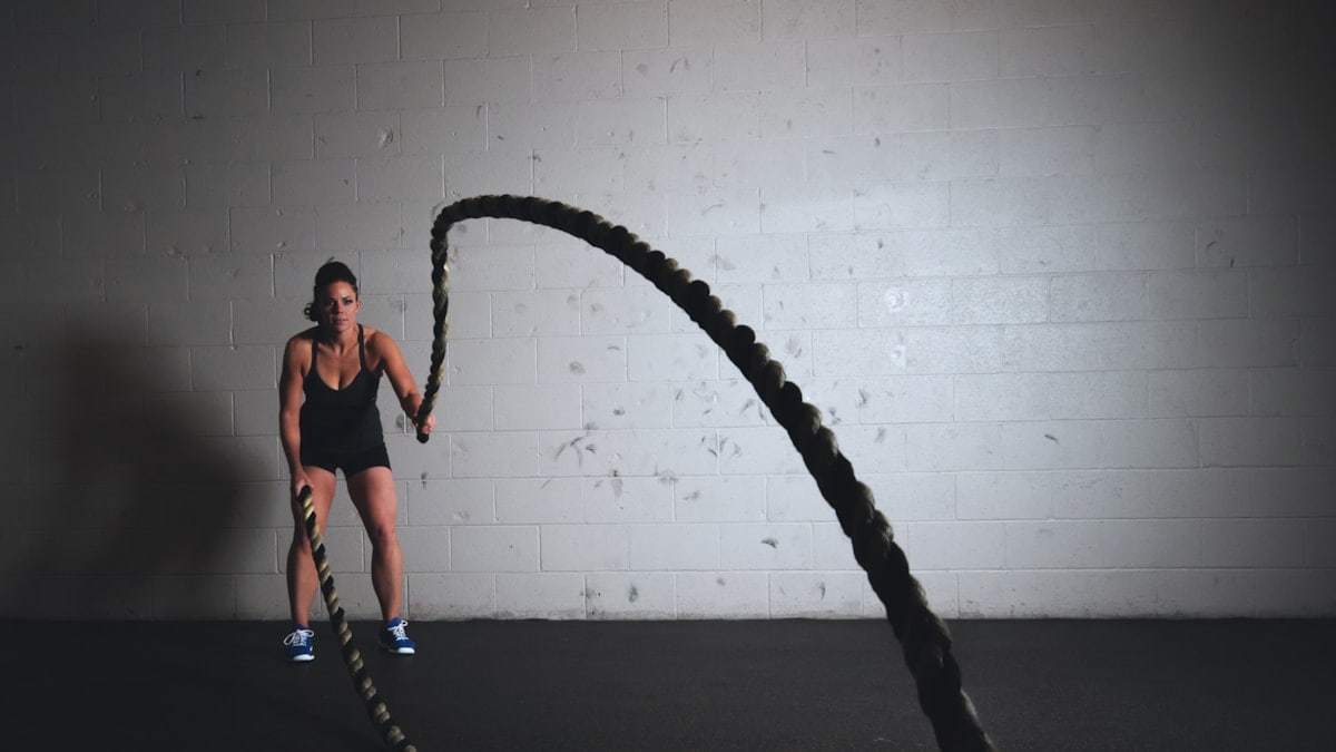 Woman working out with battle ropes and getting fit!